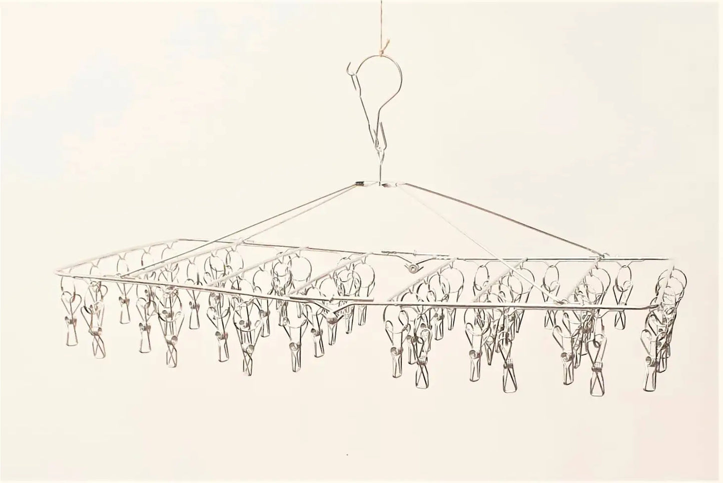 A drawing of a rectangular stainless steel compact peg hanger with 52 pegs, designed to be used for drying smaller items such as socks and underwear.